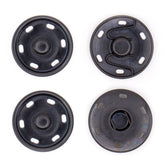 Four black snap fasteners, two with visible spring mechanisms, on a white background. DRUKKNOOP-30-ZWART-2ST