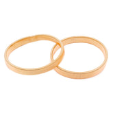 Deux brassards enroulés couleur or rose, présentés séparément sur fond blanc. MOP00004