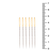 Six silver hand sewing needles with gold eyes, shown next to a ruler. COSE-10216.018 1021260180000