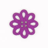 A single purple wooden flower button with cut-out petals and four holes in the center. KNP00064